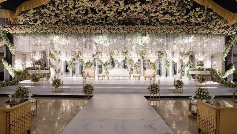 Crystal string-light stage with floral canopy