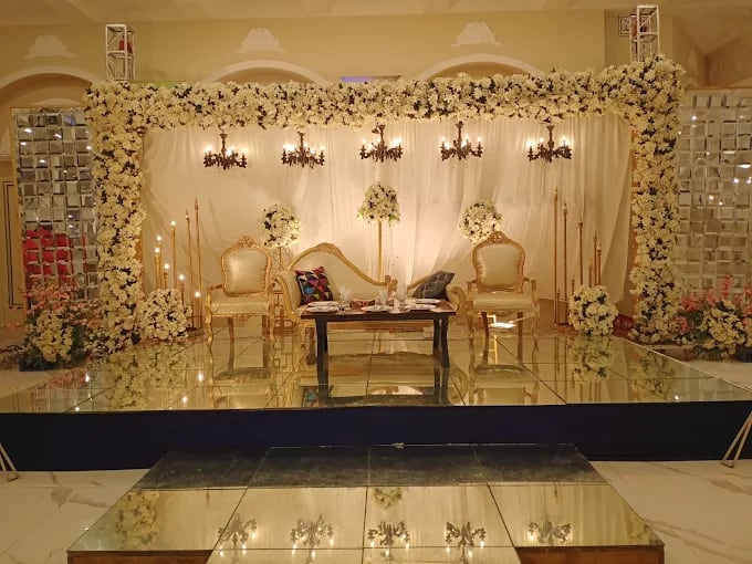 Floral arch stage with vintage chandeliers