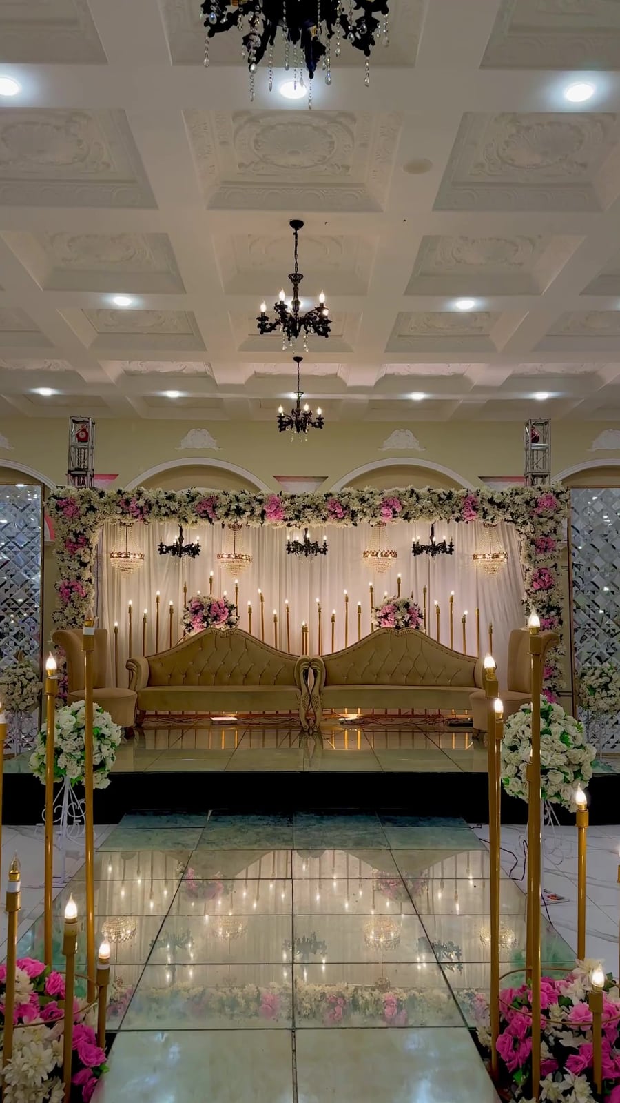 Rose-and-white floral stage with chandelier drops